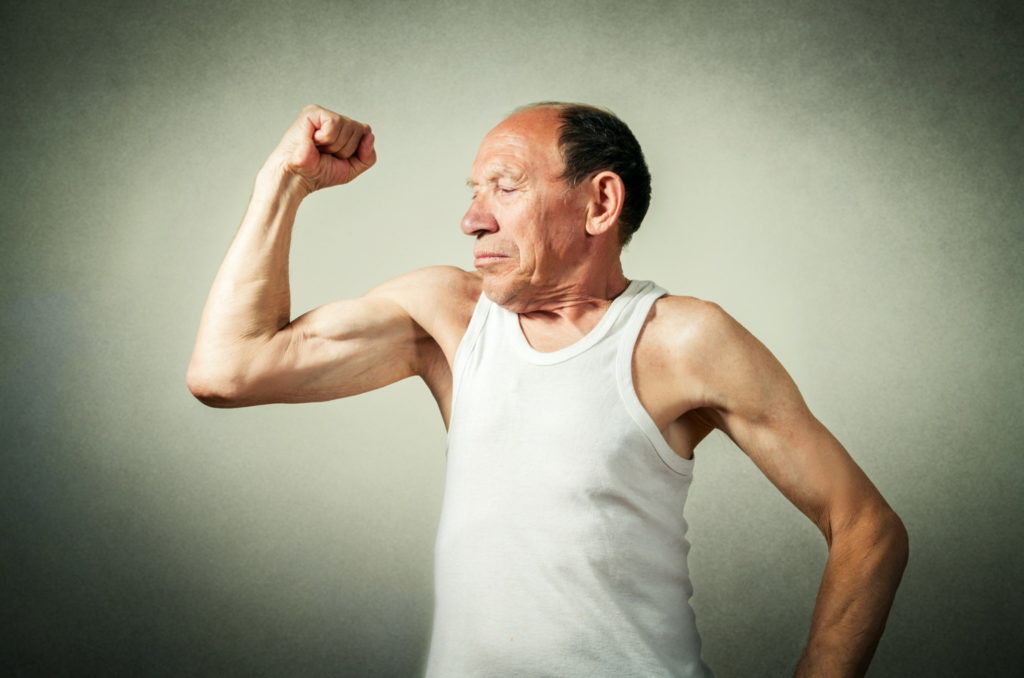 Elder man flexing his arm muscle